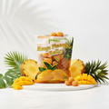 Philippine Brand Dried Mango Pineapple Balls styled with fresh tropical fruits on marble surface