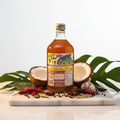 Suka Pinakurat Original Spiced Coconut Vinegar styled with Filipino spices and tropical leaves on marble